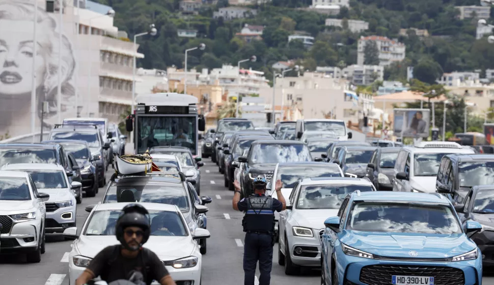 epa12130353 A policeman directs traffic following a power outage that hist South of France in Cannes, France, 24 May 2025. A massive power outage struck the French region of Alpes-Maritimes, including Cannes, on 24 May. According to the Cannes Film Festival, the closing ceremony and all scheduled events are to proceed as planned. The Palais des Festivals has its independent power supply. EPA/GUILLAUME HORCAJUELO
