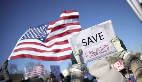 A demonstrator holds a sign reading "Save USAID" during a protest against Project 2025 and the Trump administration at the Capitol Reflecting Pool near the U.S. Capitol in Washington, D.C. on February 17, 2025. Photo by Bryan Dozier/Middle East Images/ABACAPRESS.COM Photo: Middle East Images/ABACA/ABACA