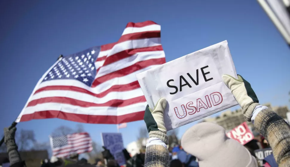 A demonstrator holds a sign reading "Save USAID" during a protest against Project 2025 and the Trump administration at the Capitol Reflecting Pool near the U.S. Capitol in Washington, D.C. on February 17, 2025. Photo by Bryan Dozier/Middle East Images/ABACAPRESS.COM Photo: Middle East Images/ABACA/ABACA