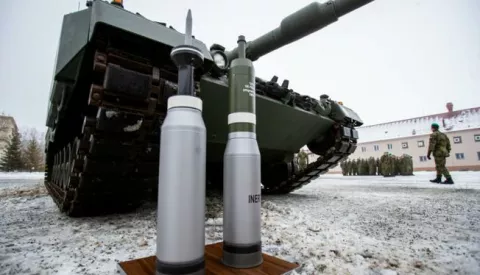 epa10375564 Ammunition standing in front of a Leopard 2A4 tank during a ceremony for the hand over of the symbolic key of the tank to the Czech army, in Praslavice, Czech Republic, 21 December 2022. The Czech Republic is to receive a total of 14 Leopard 2A4 tanks and a Bueffel armored recovery vehicle as a gift from Germany under the German government's 'Ringtausch' programme in return for deliveries of older tanks from Czech army depots to Ukraine. In addition to the tanks, the delivery will include an initial package of spare parts, ammunition and a three-year service support from the supplier, which includes training of Czech soldiers. The value of the donation exceeds 3.85 billion Czech crown (159 million euro). The rest of the military equipment is expected to be delivered to the Czech Republic next year. EPA/VLADIMIR PRYCEK