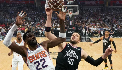 epa10586911 Los Angeles Clippers center Ivica Zubac (40) is hit out of the way as Phoenix Suns center Deandre Ayton (22) shoots the ball during the first half an NBA game at the Crypto.com Arena in Los Angeles, California, USA, 22 April 2023. EPA/ALLISON DINNER SHUTTERSTOCK OUT