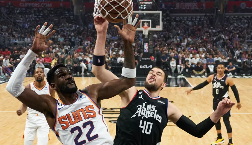 epa10586911 Los Angeles Clippers center Ivica Zubac (40) is hit out of the way as Phoenix Suns center Deandre Ayton (22) shoots the ball during the first half an NBA game at the Crypto.com Arena in Los Angeles, California, USA, 22 April 2023. EPA/ALLISON DINNER SHUTTERSTOCK OUT