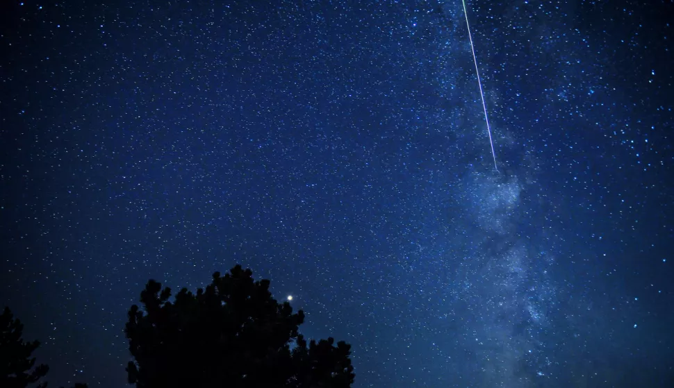 epa06944946 Meteors streak past stars of Milky Way in the night sky during the Perseid meteor shower over the lake of Kozjak, some 45km from the capitol Skopje, The Former Yugoslav Republic of Macedonia on 12 August 2018. EPA/GEORGI LICOVSKI
