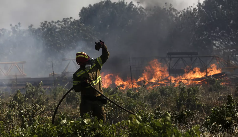 epa12214386 A firefighter tries to put out a wildfire near the areas of Pikermi and Spata, east of Athens, Greece, 03 July 2025 (issued 04 July 2025). More than 100 firefighters have been mobilized, along with six ground teams and 28 fire engines, as well as volunteers to contain the fire which broke out at the intersection of Marathonos Avenue and Arionos Street, near residential areas. EPA/YANNIS KOLESIDIS