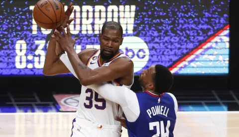 epa10583420 Phoenix Suns forward Kevin Durant (L) protects the ball from LA Clippers guard Norman Powell (R) during the fourth quarter of game three of the first round playoff series between the Phoenix Suns and the Los Angeles Clippers at Crypto.com Arena in Los Angeles, California, USA, 20 April 2023. EPA/CAROLINE BREHMAN SHUTTERSTOCK OUT