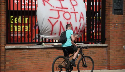 epa12213487 A cyclist passes a tribute to soccer player Diogo Jota at Anfield, the home of Liverpool FC in Liverpool, Britain 03 July 2025. Jota died in a car accident in Spain together with his brother Andre Silva on 03 July 2025. EPA/ADAM VAUGHAN
