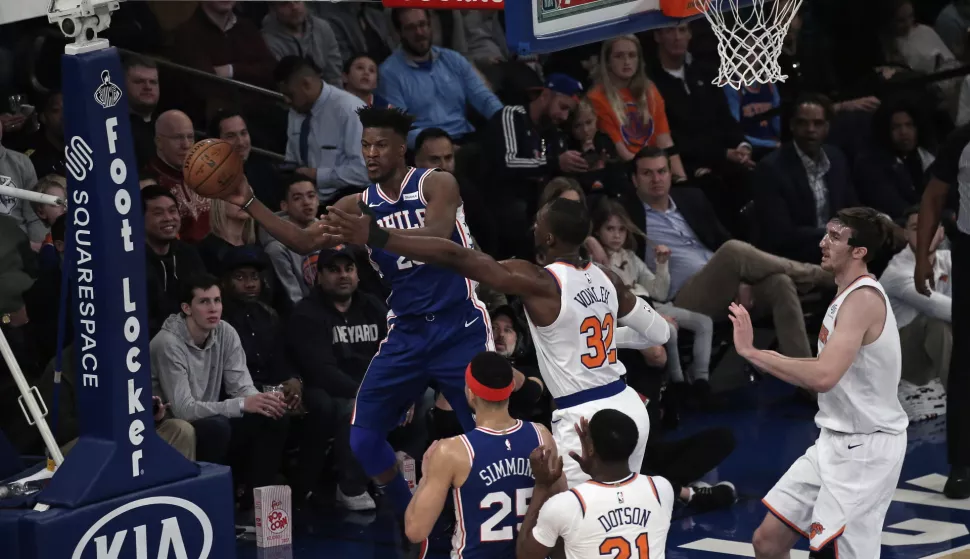 epa07280774 Philadelphia 76ers guard Jimmy Butler (L) is forced to pass by New York Knicks forward Noah Vonleh (C) in the first half of the NBA basketball game between the Philadelphia 76ers and the New York Knicks at Madison Square Garden in New York, New York, USA, 13 January 2019. EPA/PETER FOLEY SHUTTERSTOCK OUT