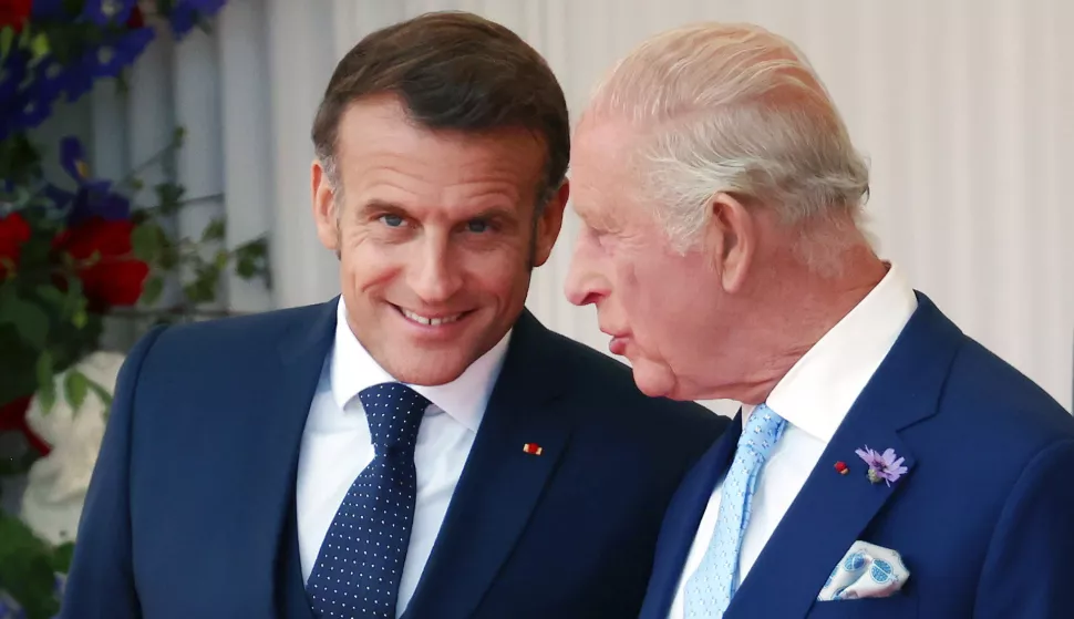 epa12224357 French President Emmanuel Macron (L) and Britain's King Charles III speak during a welcome ceremony in Windsor, Britain, 08 July 2025. French President Macron and his wife Brigitte are on a three-day state visit to Britain. EPA/ANDY RAIN
