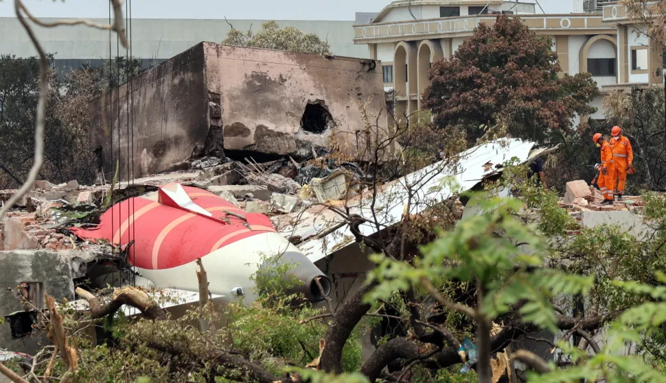 epa12174653 Officials inspect the remains of the Air India passenger plane at the crash site near Sardar Vallabhbhai Patel International Airport in Ahmedabad, Gujarat state, western India, 14 June 2025. Air India flight AI171, bound for London carrying 242 passengers and crew members on board a Boeing 787-8 aircraft, crashed minutes after take-off in the Meghaninagar area of Ahmedabad on 12 June. EPA/RAJAT GUPTA