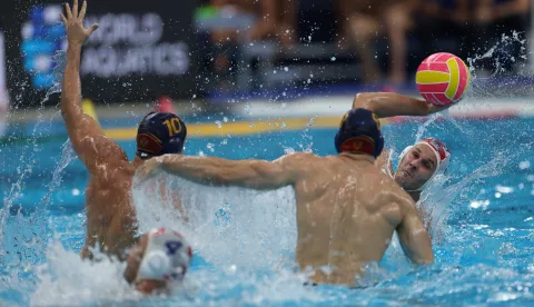epa12237289 Gardasevic Filip (2-L) of Montenegro in action against Fatovic Loren (R) of Croatia during the men's water polo match between Montenegro and Croatia at the World Aquatics Championships Singapore 2025 in Singapore, 14 July 2025. EPA/FAZRY ISMAIL