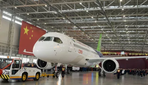 epa05007035 Workers roll out the first C919 passenger jet plane at the state-owned Commercial Aircraft Corporation of China Ltd (COMAC) in Shanghai, China 02 November 2015. China has spent seven years and huge amount to develop the 158-seat jet to boost its aviation industry, posing a challenge to Airbus and Boeing. EPA/STRINGER CHINA OUT