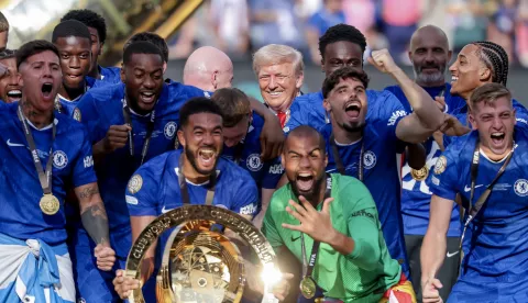 epa12236624 US President Donald Trump (Back-C) looks on as Chelsea FC players celebrate with the trophy after winning the FIFA Club World Cup 2025 final match between Chelsea FC and Paris Saint-Germain, in East Rutherford, New Jersey, USA, 13 July 2025. EPA/JUSTIN LANE
