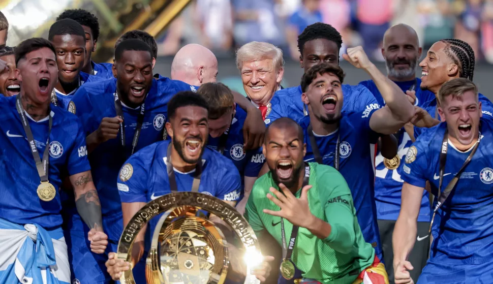 epa12236624 US President Donald Trump (Back-C) looks on as Chelsea FC players celebrate with the trophy after winning the FIFA Club World Cup 2025 final match between Chelsea FC and Paris Saint-Germain, in East Rutherford, New Jersey, USA, 13 July 2025. EPA/JUSTIN LANE