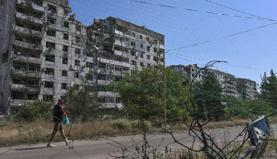 epa12239951 A handout photo made available by the press service of the 65th Separate Mechanised Brigade of Ukrainian Armed Forces shows a local man walking on a street protected by the anti-drone nets of various types amid the ongoing Russian invasion in the city of Orikhiv, Zaporizhzhia region, Ukraine, 15 July 2025. Russian troops entered Ukrainian territory on 24 February 2022, starting a conflict that has provoked destruction and a humanitarian crisis. EPA/Press service of the 65th Mechanized Brigade/HANDOUT HANDOUT EDITORIAL USE ONLY/NO SALES