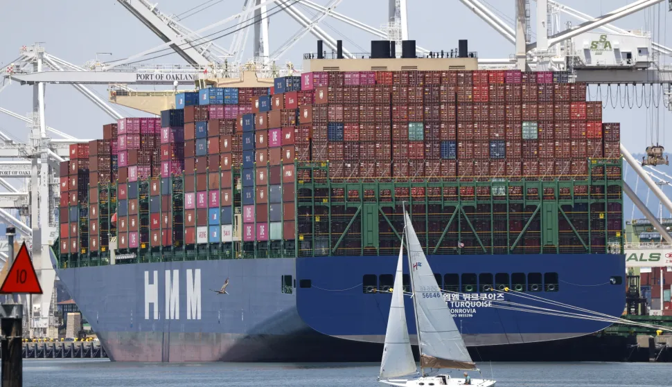 epaselect epa12238224 A sailboat sails past a container ship at the Port of Oakland in Oakland, California, USA, 14 July 2025. Recent tariff increases and trade policies, particularly those related to China, have significantly affected the port's operations and container volume. Shipping lines have been canceling voyages and skipping ports (known as 'blank sailings') in response to the uncertainty and reduced demand caused by tariffs, leading to a decline in container traffic at the Port of Oakland. Last week, US President Trump sent a letter to European Union leaders stating that he would impose a 30 percent tariff on goods imported from the EU beginning 01 August. Trump also threatened to impose 25 percent tariffs on Japan and South Korea, 30 percent on Mexico, and 35 percent on Canada. EPA/JOHN G. MABANGLO