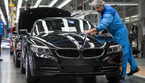 A worker conducts a final inspection of a BMW car model Z4 Roadster during the final inspection in the assembly plant of car manufacturer BMW in Regensburg, Germany, 13 March 2014. Photo: Armin Weigel/dpa/DPA/PIXSELL