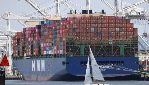 epaselect epa12238224 A sailboat sails past a container ship at the Port of Oakland in Oakland, California, USA, 14 July 2025. Recent tariff increases and trade policies, particularly those related to China, have significantly affected the port's operations and container volume. Shipping lines have been canceling voyages and skipping ports (known as 'blank sailings') in response to the uncertainty and reduced demand caused by tariffs, leading to a decline in container traffic at the Port of Oakland. Last week, US President Trump sent a letter to European Union leaders stating that he would impose a 30 percent tariff on goods imported from the EU beginning 01 August. Trump also threatened to impose 25 percent tariffs on Japan and South Korea, 30 percent on Mexico, and 35 percent on Canada. EPA/JOHN G. MABANGLO