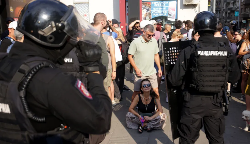 epa12221728 A protestor sits in front of riot police officers as they disperse a blockade organized by students and anti-government demonstrators in Belgrade, Serbia, 07 July 2025. University students and protesters are demanding snap elections and the release of detained demonstrators. EPA/ANDREJ CUKIC