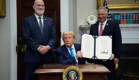 epa12273463 US President Donald Trump (C), flanked by US Representatives Derrick Van Orden (Republican from Wisconsin) and Mike Bost (Republican from Illinois), shows the signed Congressional Bill in the Roosevelt Room at the White House in Washington, SC, USA, 30 July 2025. EPA/YURI GRIPAS/POOL