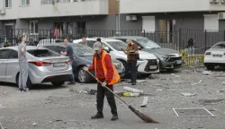 epa12159489 Communal workers clean debris at the site of a high-rise residential building struck by a drone during a massive overnight attack in Kyiv, Ukraine, 06 June 2025, amid the ongoing Russian invasion. At least three people were killed and more than 40 injured after Russia launched a large-scale combined assault using at least 44 missiles and nearly 407 drones across Ukraine, according to the State Emergency Service. EPA/SERGEY DOLZHENKO