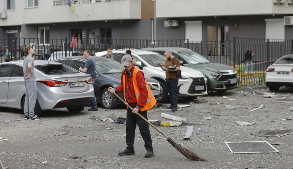 epa12159489 Communal workers clean debris at the site of a high-rise residential building struck by a drone during a massive overnight attack in Kyiv, Ukraine, 06 June 2025, amid the ongoing Russian invasion. At least three people were killed and more than 40 injured after Russia launched a large-scale combined assault using at least 44 missiles and nearly 407 drones across Ukraine, according to the State Emergency Service. EPA/SERGEY DOLZHENKO