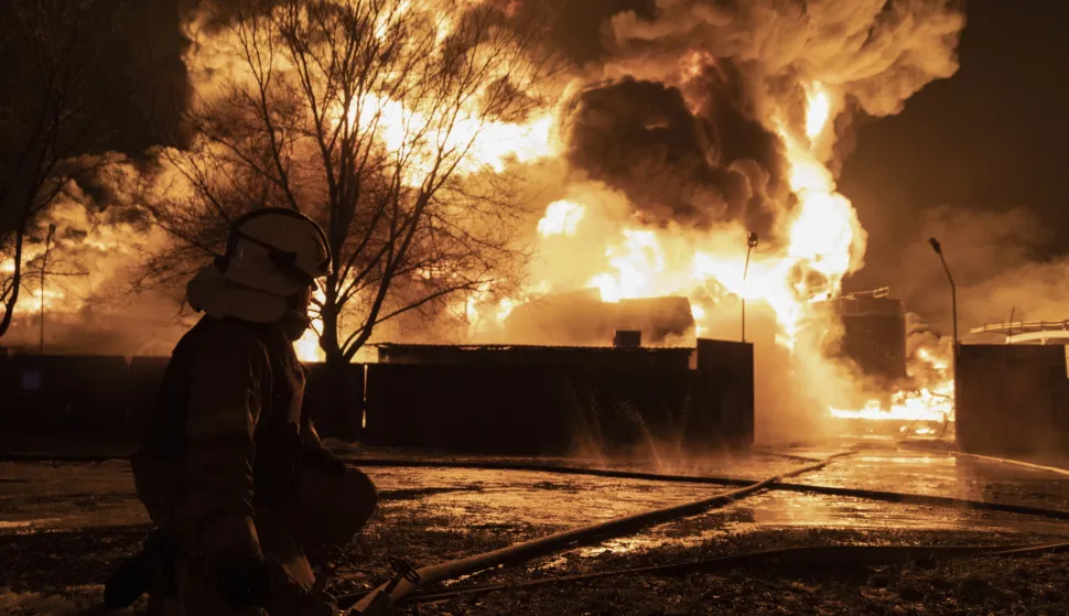 epa11142858 Firefighters work at the site of a fire after a drone strike on a oil depot in Kharkiv, northeastern Ukraine, 10 February 2024, amid the Russian invasion. At least seven people were killed, including three children, due to a fire after Russian shelling on the Nemyshlyan district of Kharkiv overnight 10 February, the chief of the local administration Oleh Syniehubov wrote on telegram. EPA/YAKIV LIASHENKO