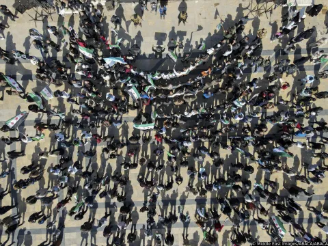 People hold flags in a dense crowd in Aleppo, Syria, on March 7, 2025. The gathering takes place after Friday prayers as citizens rally in support of the new government and its military operations against the ousted regime forces. Photo by Hibatullah Barakat/Middle East Images/ABACAPRESS.COM Photo: Middle East Images/ABACA/ABACA