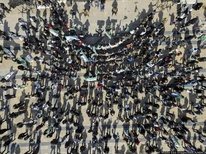People hold flags in a dense crowd in Aleppo, Syria, on March 7, 2025. The gathering takes place after Friday prayers as citizens rally in support of the new government and its military operations against the ousted regime forces. Photo by Hibatullah Barakat/Middle East Images/ABACAPRESS.COM Photo: Middle East Images/ABACA/ABACA