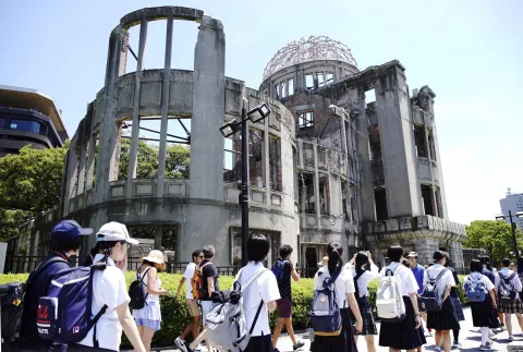 epa07757888 School students walk before the Atomic Bomb Dome at Hiroshima Peace Memorial Park in Hiroshima, western Japan, 05 August 2019. Hiroshima will mark 74th anniversary of the atomic bombing on 06 August 2019. EPA/JIJI PRESS JAPAN OUT EDITORIAL USE ONLY/ NO ARCHIVES