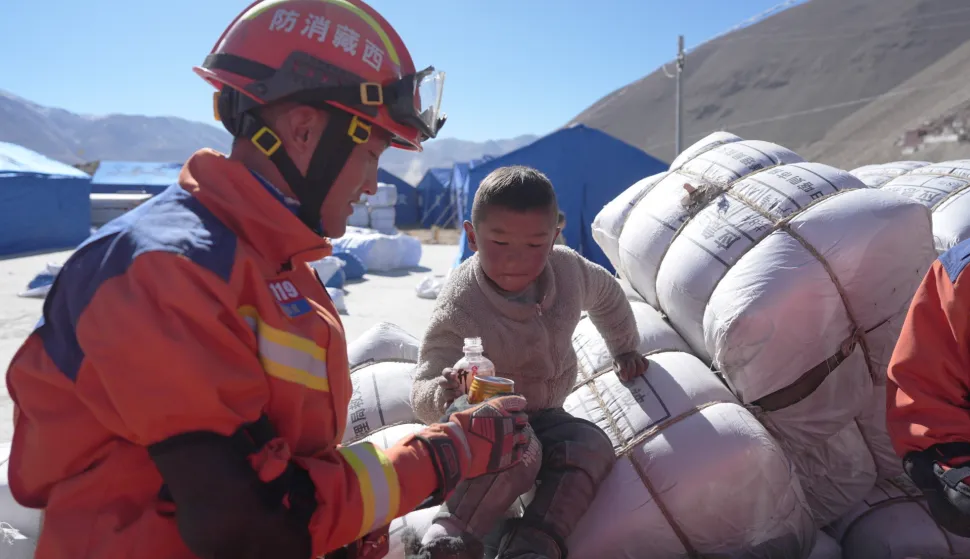 epa11813211 A fire rescuer interacts with a child at a relocation site in a village of Dingri County in Xigaze City, southwest China's Xizang Autonomous Region, 08 January 2025. Rescue and relief efforts were made after a 6.8-magnitude earthquake struck Dingri County in southwest China's Xizang Autonomous Region on 07 January 2025. EPA/XINHUA/JIGME DORJE CHINA OUT/UK AND IRELAND OUT/  MANDATORY CREDIT EDITORIAL USE ONLY