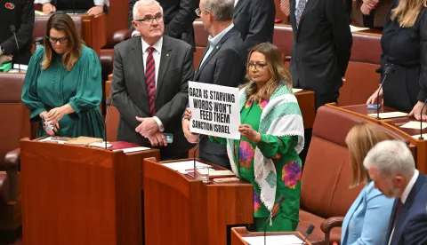 epa12252531 Greens Senator Mehreen Faruqi (Center R) protests as Australian Prime Minister Anthony Albanese (not pictured) walks out of the Senate chamber for the opening of the 48th Federal Parliament at Parliament House in Canberra, Australia, 22 July 2025. EPA/Mick Tsikas AUSTRALIA AND NEW ZEALAND OUT