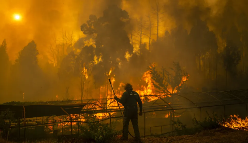 epa12307292 A forest guard works to extinguish a forest fire in Carballeda de Avia, Ourense, Galicia, north-western Spain, 17 August 2025. Multiple blazes continue to affect several provinces in Spain, after burning thousands of hectares across the country. In Galicia, 50,000 hectares have already burned, and in Castile and Leon (central Spain), 3,500 people remain outside their homes. EPA/BRAIS LORENZO