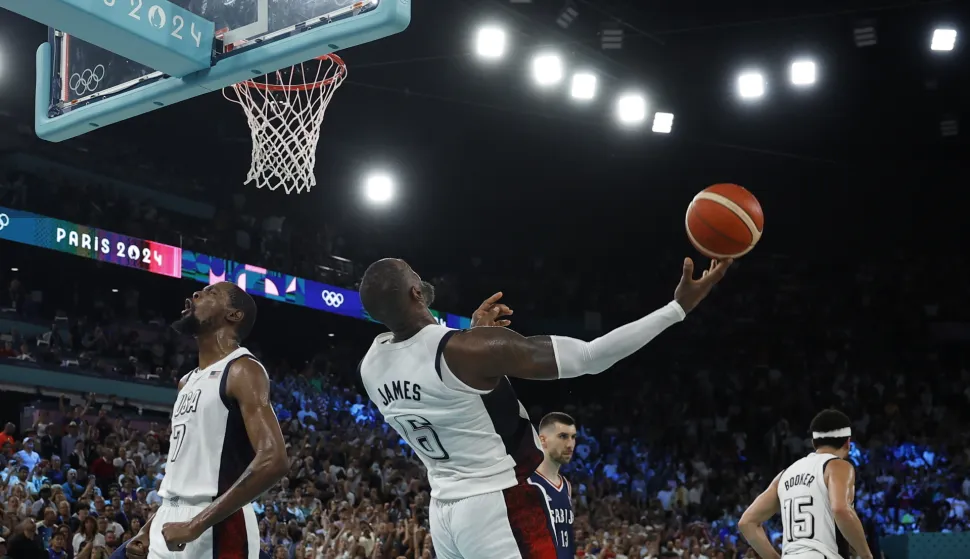 epa11538314 Lebron James (C) and Kevin Durant of USA (L) react after winning the Men's semi final match between USA and Serbia of the Basketball competitions in the Paris 2024 Olympic Games, at the South Paris Arena in Paris, France, 08 August 2024. EPA/YOAN VALAT