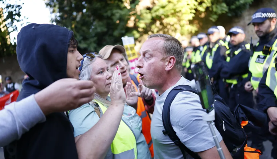 epa12316970 A protestor is confronted as anti-racist protestors march towards the TLK Apartments Hotel housing asylum seekers during a demonstration against the far-right in Orpington, Britain, 22 August 2025. Far-right protests outside hotels housing migrants have been increasing across the UK in recent weeks, with counter-protests also taking place. EPA/TOLGA AKMEN