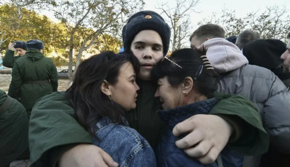 epa10296355 A Russian conscript bids farewell to his relatives before he leaves to serve in the army at a railway station in Sevastopol, Crimea, 09 November 2022. In 2022, as part of the autumn conscription, the number of those called up for military service will be 120 thousand people. Male citizens of the Russian Federation aged 18 to 27 who have not previously completed military service fall under the autumn draft. Conscripts of the autumn conscription will not be sent to serve in the DPR, LPR, Zaporizhzhia and Kherson regions. EPA/STRINGER