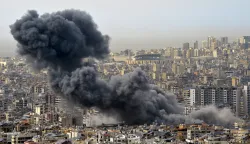 epa11994967 Smoke is seen billowing over buildings in Dahieh, southern Beirut, Lebanon, 28 March 2025. At least two missiles hit a building in the Hadath area, which was destroyed by the attack after an Israeli military warning earlier on 28 March, according to the Lebanese National News Agency (NNA). EPA/WAEL HAMZEH