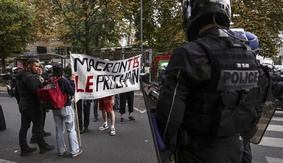epa12362938 Police officers block a group of people carrying a banner reading 'Macron, you're next' during a spontaneous rally following the rejection of the vote of confidence requested for Prime Minister Fran&ccedil;ois Bayou, in Montreuil, Paris, France, 08 September 2025. French Prime Minister Francois Bayrou has lost the vote of confidence after he activated Article 49.1 of the Constitution. EPA/TERESA SUAREZ