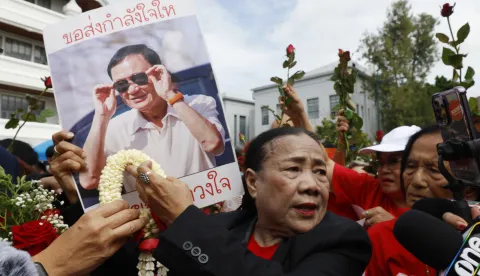 epa12363586 Supporters of former Thai Prime Minister Thaksin Shinawatra hold up his portrait as he arrives to hear a verdict on the case regarding his prolonged hospital stay to avoid a prison sentence, at the Supreme Court in Bangkok, Thailand, 09 September 2025. The Supreme Court's Criminal Division for Holders of Political Positions is set to rule on the enforcement of the former premier's controversial hospital stay to avoid serving his prison term. EPA/NARONG SANGNAK