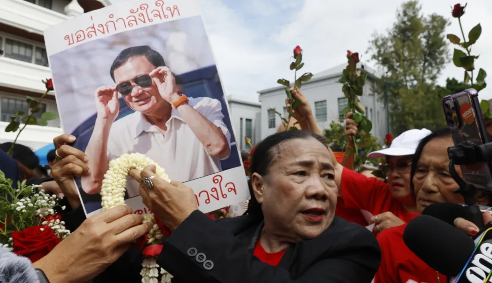 epa12363586 Supporters of former Thai Prime Minister Thaksin Shinawatra hold up his portrait as he arrives to hear a verdict on the case regarding his prolonged hospital stay to avoid a prison sentence, at the Supreme Court in Bangkok, Thailand, 09 September 2025. The Supreme Court's Criminal Division for Holders of Political Positions is set to rule on the enforcement of the former premier's controversial hospital stay to avoid serving his prison term. EPA/NARONG SANGNAK