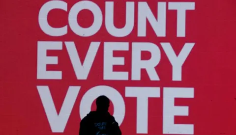 epaselect epa08799520 A singer performs in front of a monitor that reads 'Count Every Vote' at a rally to demand all votes are counted the day after election day at McPherson Square, near the White House in Washington, DC, USA, 04 November 2020. Americans voted to choose between re-electing Donald J. Trump or electing Joe Biden as the 46th President of the United States to serve from 2021 through 2024. Trump has claimed victory and alleged election fraud has been committed, without citing any evidence. EPA/MICHAEL REYNOLDS