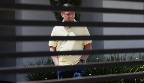 epa12349669 Brazil's former president Jair Bolsonaro walks at his residence in Brasilia, Brazil, 03 September 2025. Bolsonaro's defense team denied before the Supreme Court that the former Brazilian president participated in a coup plot and reduced the prosecution's accusation to 'suppositions' in a session that has left the trial ready for sentencing. EPA/SEBASTIAO MOREIRA