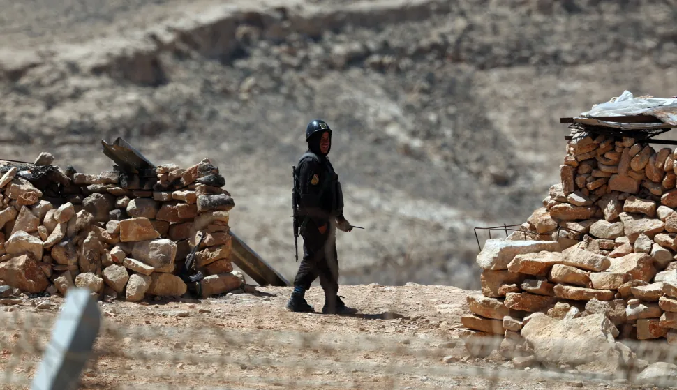 epa12035255 An Egyptian soldier patrols on the Egyptian side of the border as seen from Israel across the fence that runs along the Israeli-Egyptian border in the south of Israel, 16 April 2025. The location normally closed to tourists is partially open during the Passover holiday. The border runs approximately 246 kilometers, from Rafah in the Gaza Strip to Eilat on the Red Sea. EPA/ATEF SAFADI