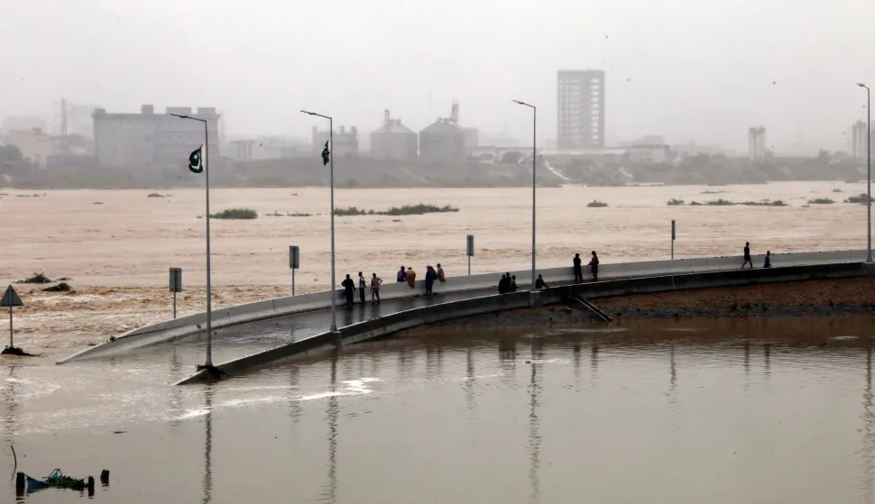 epa12367491 People inspect a partially submerged road amid a fast-flowing torrent in Karachi, Pakistan, 10 September 2025. Heavy monsoon rains, which began on 26 June, continue to cause widespread devastation across Pakistan, with the Sindh Province on high alert as 1.6 million people are at risk of a potential 'super flood', according to The United Nations Office for the Coordination of Humanitarian Affairs (OCHA). EPA/REHAN KHAN