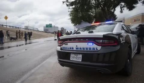 epa12402429 A Dallas Police car parked outside a press conference following a shooting at the United States Immigration and Customs Enforcement (ICE) Field Office, in Dallas, Texas, USA, 24 September 2025. At least two people were killed, the Dallas Police confirmed. According to the US Homeland Security secretary, the shooter also died from 'a self-inflicted gunshot wound' EPA/DANIEL MCGREGOR HUYER