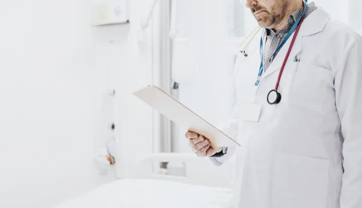 Doctor reading a coronavirus patient medical chart