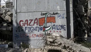 epa12393357 A graffiti on a wall reading 'Gaza is fighting alone' among destroyed buildings in Gaza City, Gaza Strip, 19 September 2025 (issued 20 September 2025). More than 65,200 Palestinians have been killed in the Gaza Strip since October 2023, according to the Palestinian Ministry of Health, and about 1,200 Israelis have been killed since the launch of an Israeli military campaign in response to a cross-border attack by Hamas on 07 October 2023. EPA/MOHAMMED SABER
