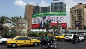 epa12237042 Cars and motorbikes drive past a billboard featuring a picture of Iranian Supreme Leader Ayatollah Ali Khamenei at Valiasr Square in Tehran, Iran, 14 July 2025. A US-mediated ceasefire between Iran and Israel started on 24 June, ending a new escalation?in the conflict that began on 13 June after Israel launched a military campaign across Iran, prompting Iran to conduct retaliatory waves of missiles and drones toward Israel. EPA/ABEDIN TAHERKENAREH