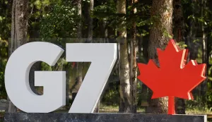 epa12179372 The logo of the Group of Seven, G7, with a Canadian red maple leaf is on display before the official arrival ceremony of the G7 Summit at the Pomeroy Kananaskis Mountain Lodge, in Kananaskis, Alberta, Canada, 16 June 2025. EPA/LUDOVIC MARIN/POOL