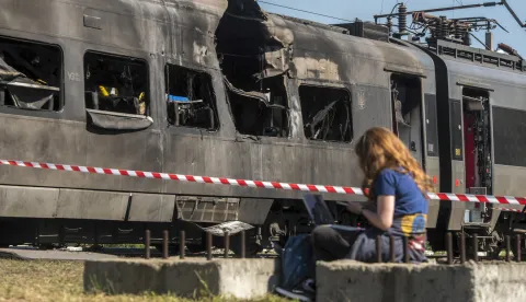 epa12329346 A woman sits by an Intercity+ high-speed passenger train damaged in a morning Russian attack in Kyiv, Ukraine, 28 August 2025, amid the ongoing Russian invasion. Russia struck the Intercity train depot and a railway junction in Kyiv, damaging one train but causing no injuries among depot workers, who were in shelters, according to Ukrzaliznytsia Chairman Oleksandr Pertsovsky. At least 14 people, including three children, were killed and 38 injured in the capital as Russia launched an overnight attack with 598 drones and 31 missiles, according to the State Emergency Service. EPA/MAXYM MARUSENKO