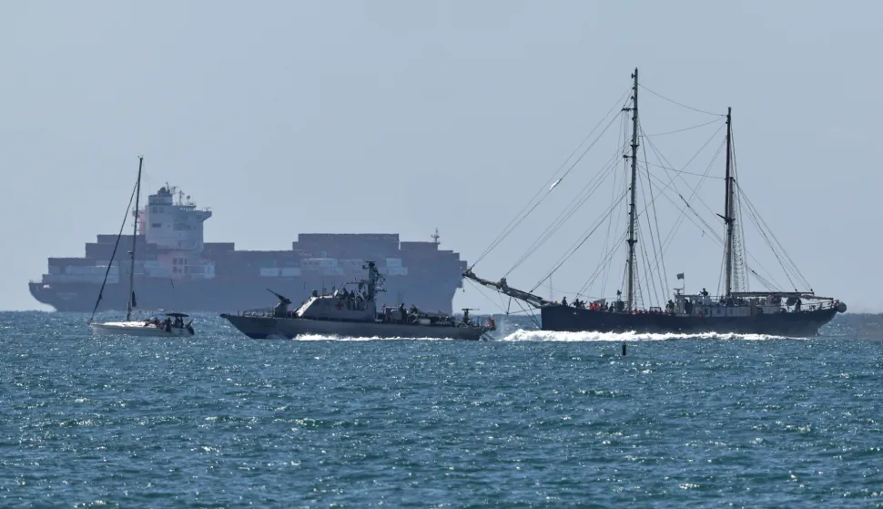epa12423880 A vessel of the Global Sumud Flotilla (L) arrives at Ashdod port, Israel, 02 October 2025, after being intercepted by the Israeli authorities while carrying aid to Gaza. Israel's Foreign Ministry announced that several vessels that form part of the Global Sumud Flotilla (GSF) had been stopped and that those aboard were being transferred to an Israeli port. EPA/ATEF SAFADI